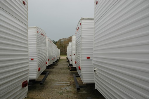looking through the center of rows of white mobile homes