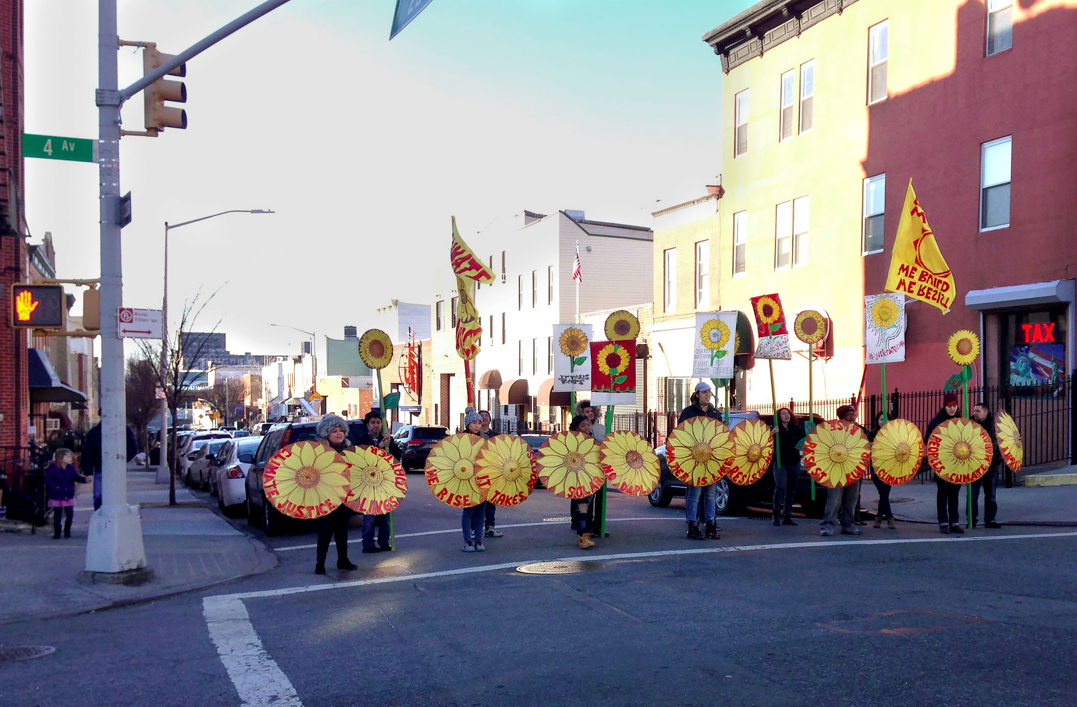 Members of UPROSE on the streets of Sunset Park brandishing "Climate Justice" and "Solar" signs in preparation for the People's Climate March in Washington DC in 2017. Photo by Amy Howden-Chapman