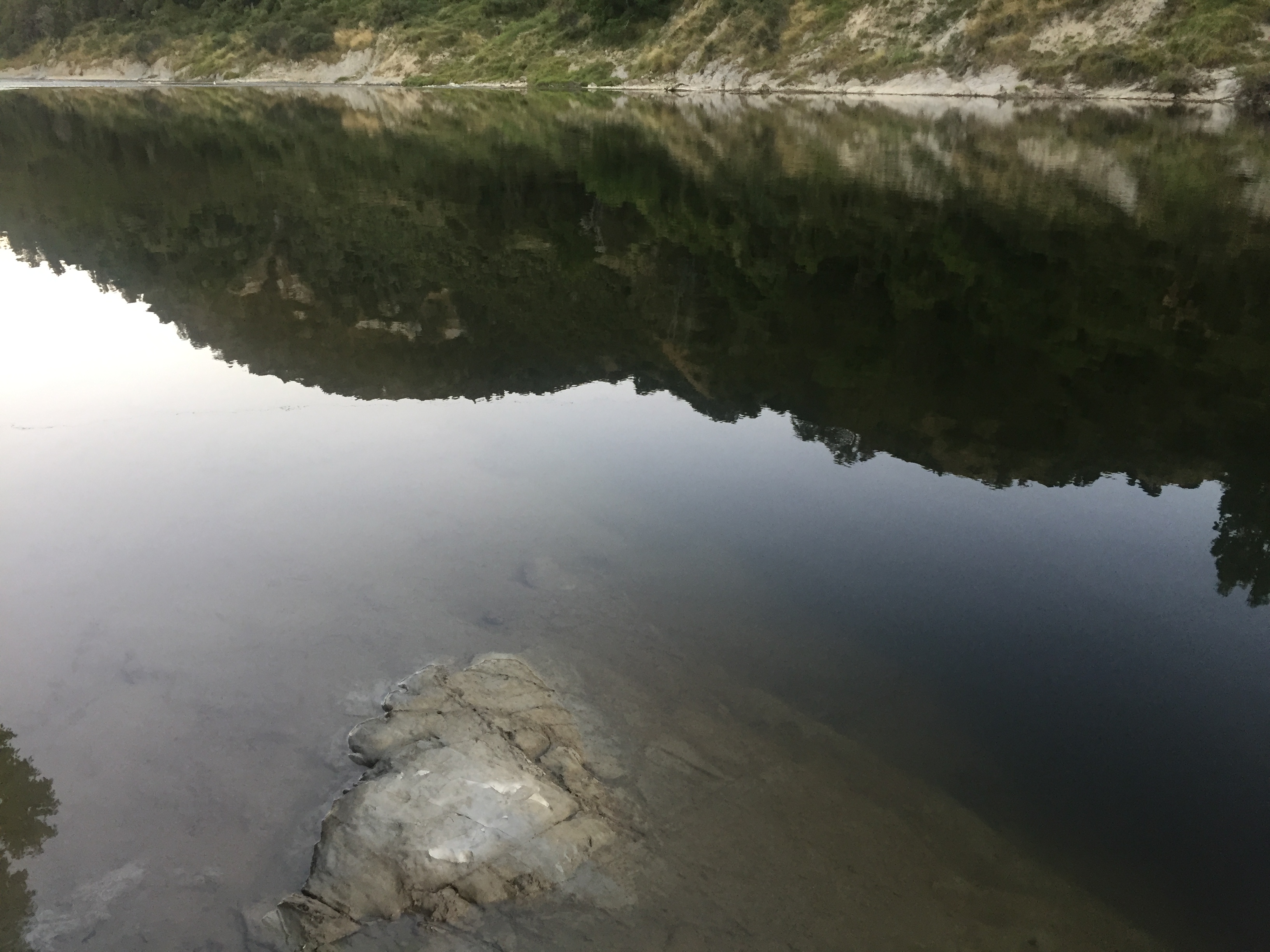 Close-up of water from the Whanganui River, which is reflecting the hills flanking it