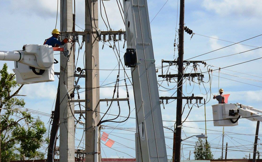 Workers repair power lines in San Juan, Puerto Rico.