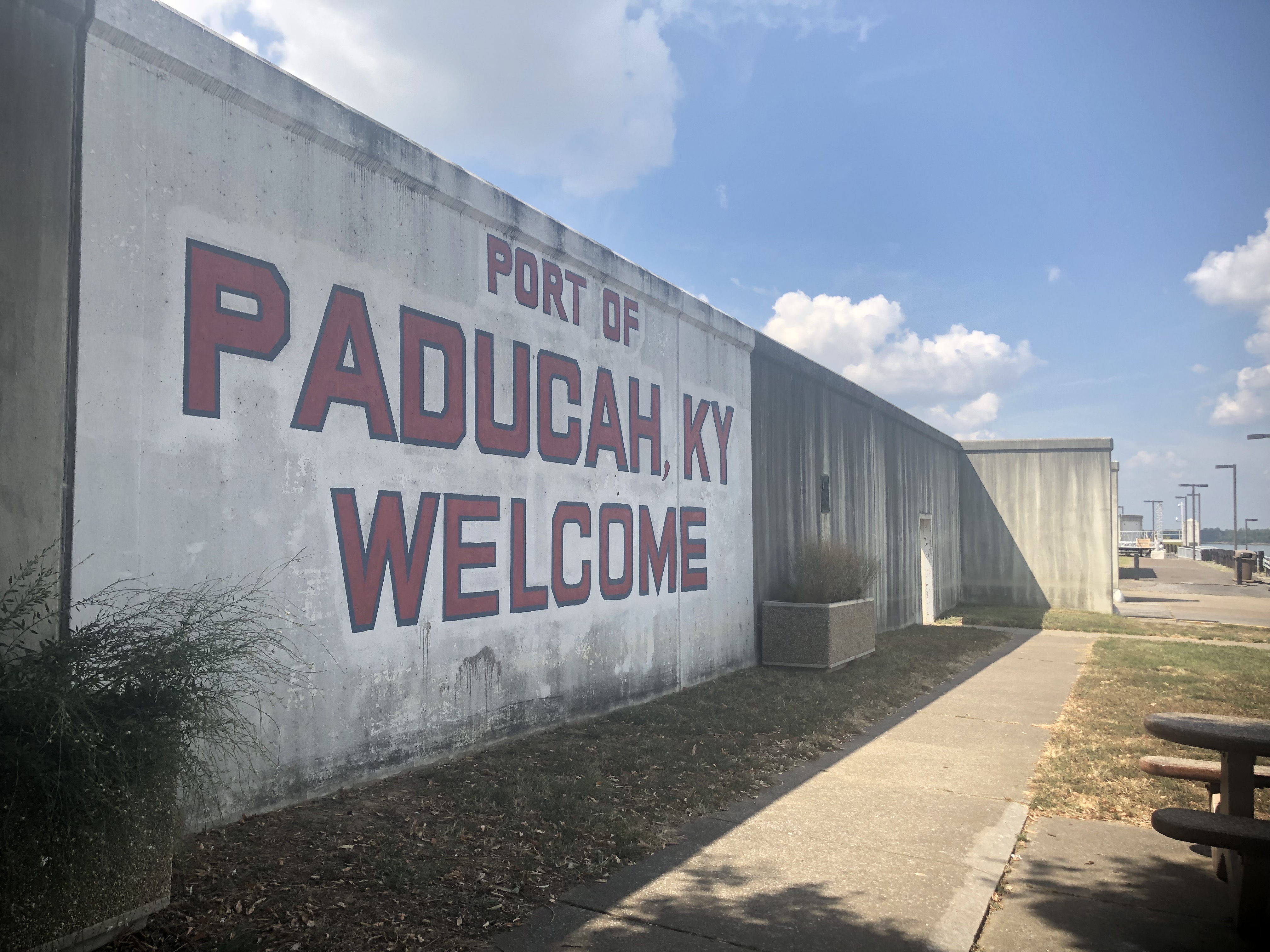 The flood wall separates the Ohio River from downtown Paducah. The wall is adorned with some text in red, bold capital letters that read "Port of Paducah, KY Welcome." In February of 2019 Ohio River flooding caused Paducah to put up its floodgates. The Paducah Gaseous Diffusion Plant is just a few miles from the Ohio River.