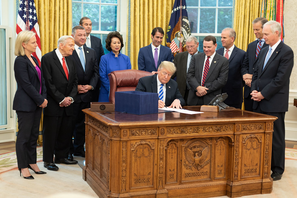 President Donald J. Trump signs H.R. 302, the FAA Reauthorization Act of 2018, in the Oval Office of the White House, October 5, 2018. Official White House Photograph by Joyce N. Boghosian.