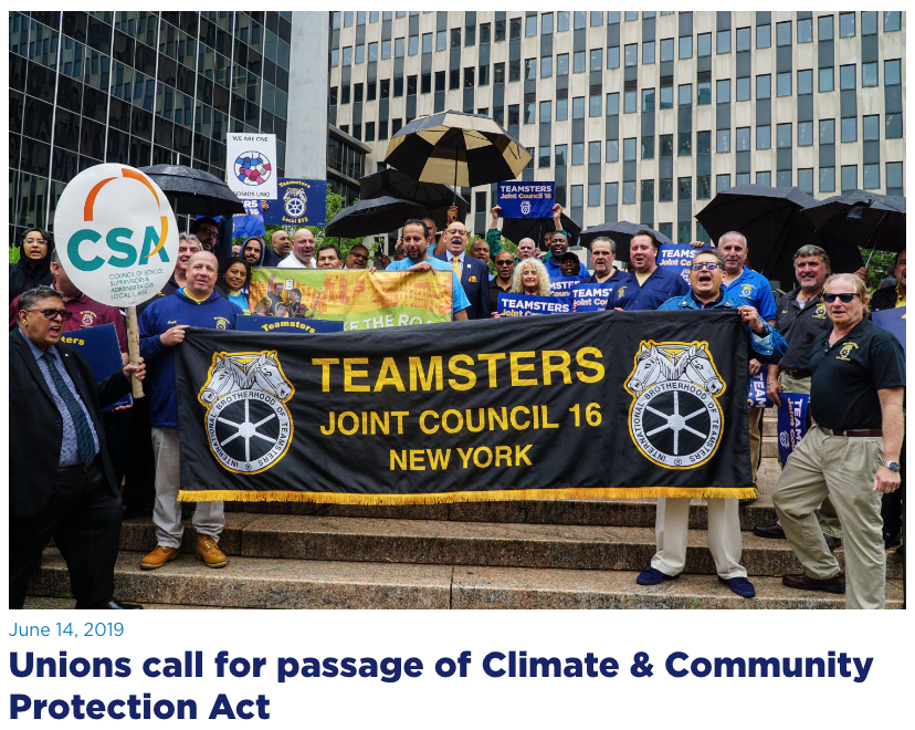 Unions call for the passage of Climate & Community Protection Act, holding signs and banners, the largest reads, "TEAMSTERS Joint Council 16 New York"