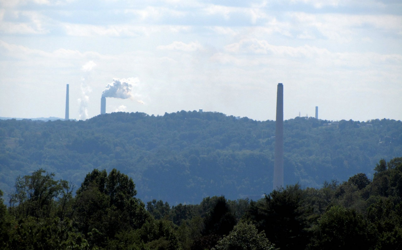 Smokestacks jutting out from the tree cover of the Ohio Valley 