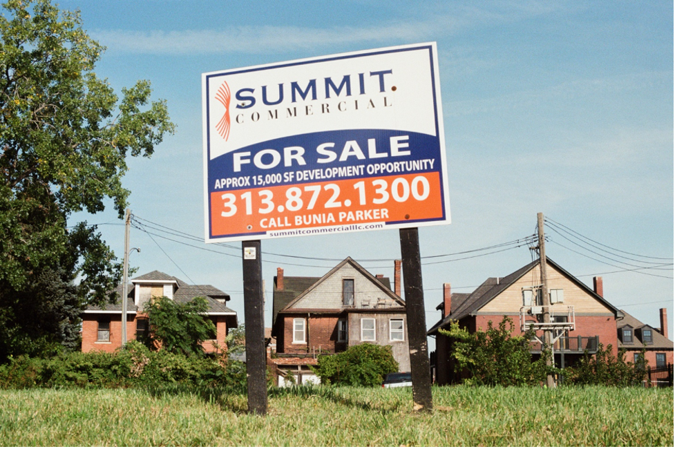 A “for sale” sign stands on vacant land in the Brush Park neighborhood of Detroit